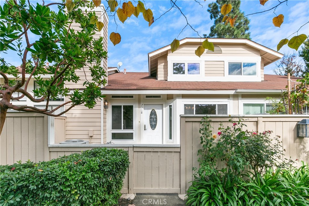 7718 Rambling Brook Way Stanton, CA 90680 - Photo 2 of 23 a front view of a house with a yard