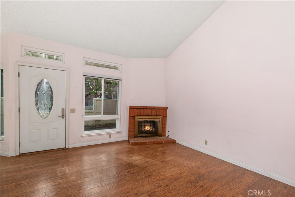 7718 Rambling Brook Way Stanton, CA 90680 - Photo 5 of 23 a view of a livingroom with an empty space and a fireplace