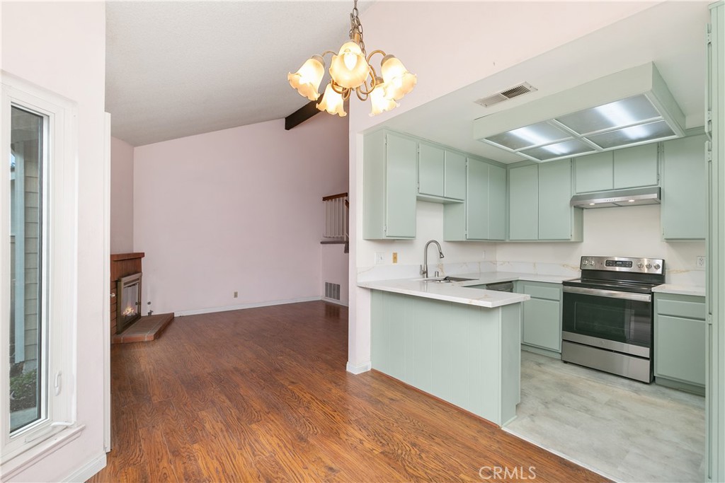 7718 Rambling Brook Way Stanton, CA 90680 - Photo 7 of 23 a kitchen with a sink and stove