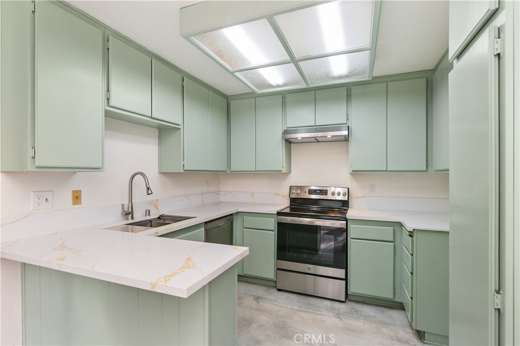 7718 Rambling Brook Way Stanton, CA 90680 - Photo 8 of 23 a kitchen with a stove and a sink