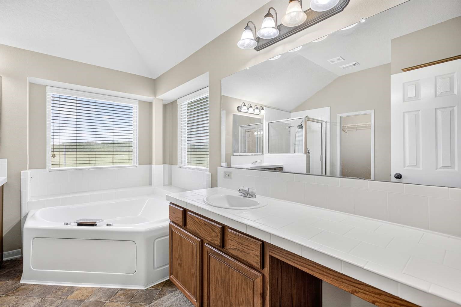 329 Gou Hole Road Cove, TX 77523 - Photo 4 of 19 a bathroom with a sink a large mirror and a bathtub