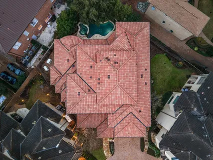 an aerial view of a house with a yard