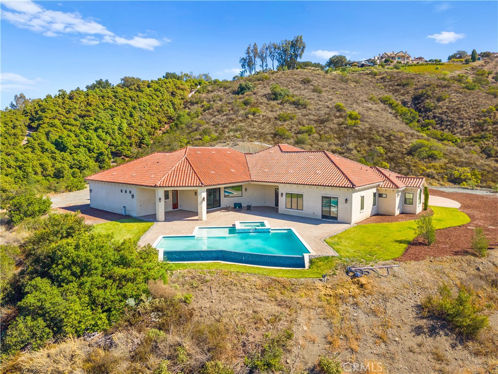 25700 El Chaval Place Temecula, CA 92590 - Photo 13 of 66 a view of a house with a yard and sitting area