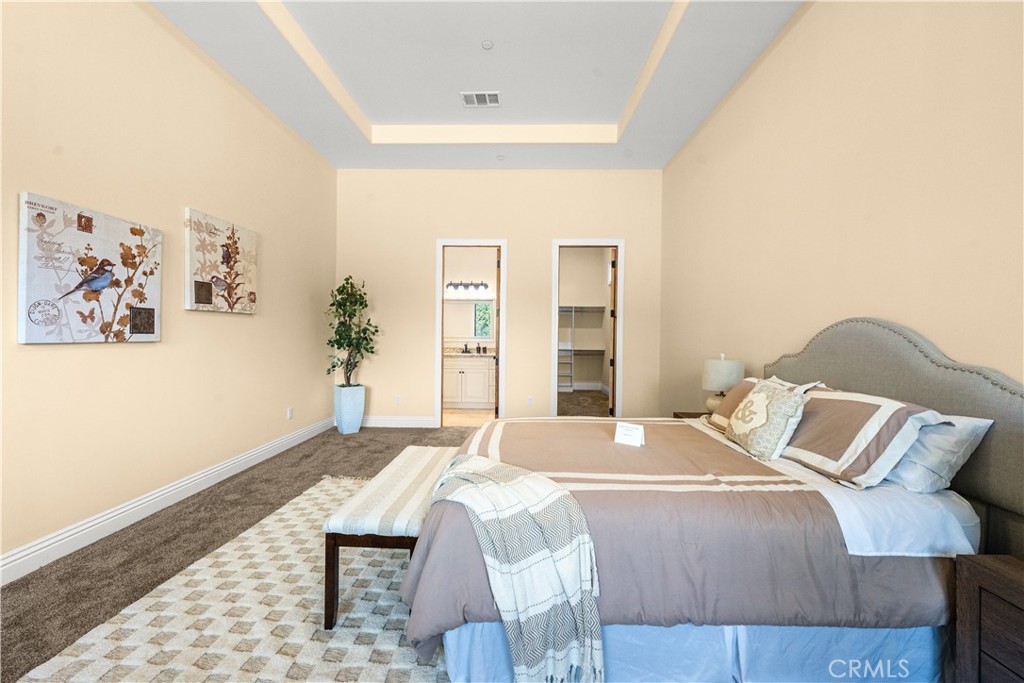 25700 El Chaval Place Temecula, CA 92590 - Photo 30 of 66 a bedroom with a bed and a painting on the wall