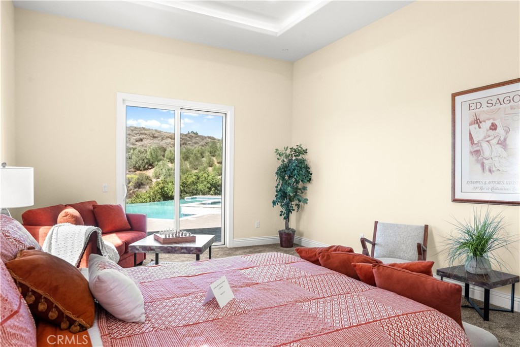 25700 El Chaval Place Temecula, CA 92590 - Photo 40 of 66 a bedroom with furniture and a large window