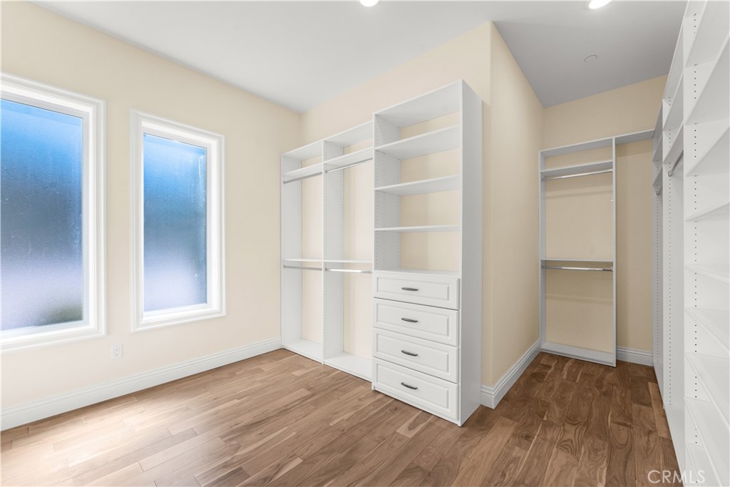 25700 El Chaval Place Temecula, CA 92590 - Photo 43 of 66 an empty room with cabinet and wooden floor