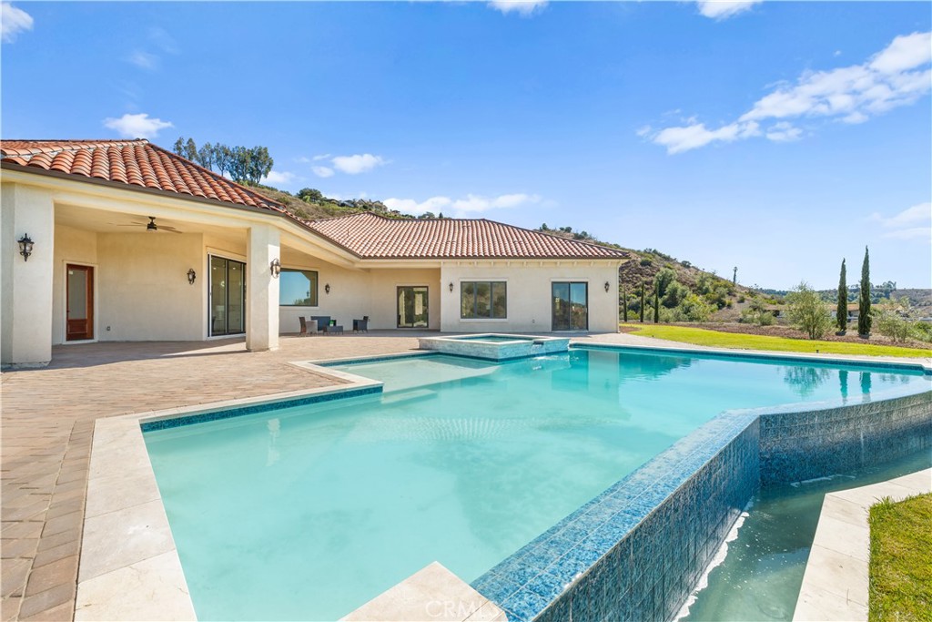 25700 El Chaval Place Temecula, CA 92590 - Photo 53 of 66 a view of a house with a swimming pool