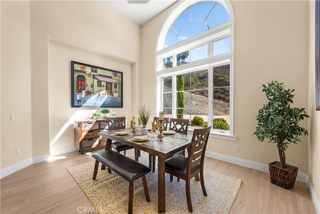 a dining room with furniture a window and a chandelier