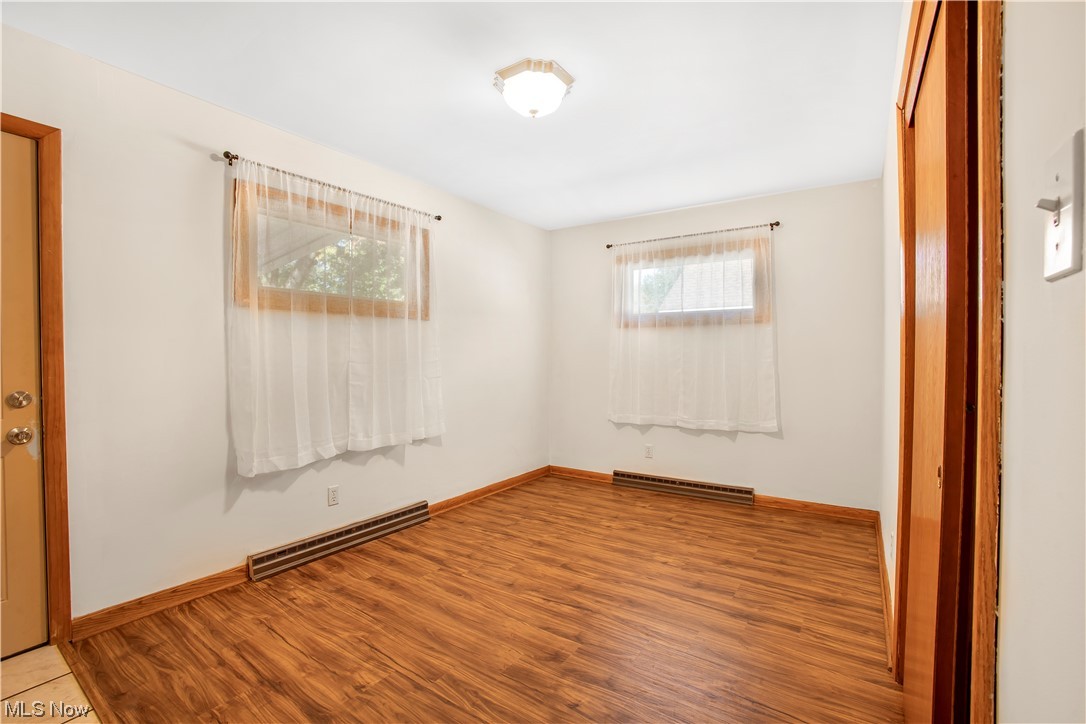 1590 Norledge Road Akron, OH 44305 - Photo 8 of 21 Spare room with light wood-type flooring and a baseboard radiator