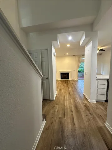a view of a hallway with wooden floor and staircase