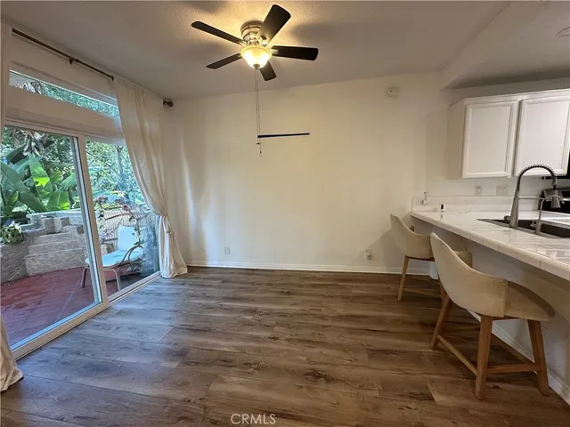 a kitchen with a sink cabinets and wooden floor