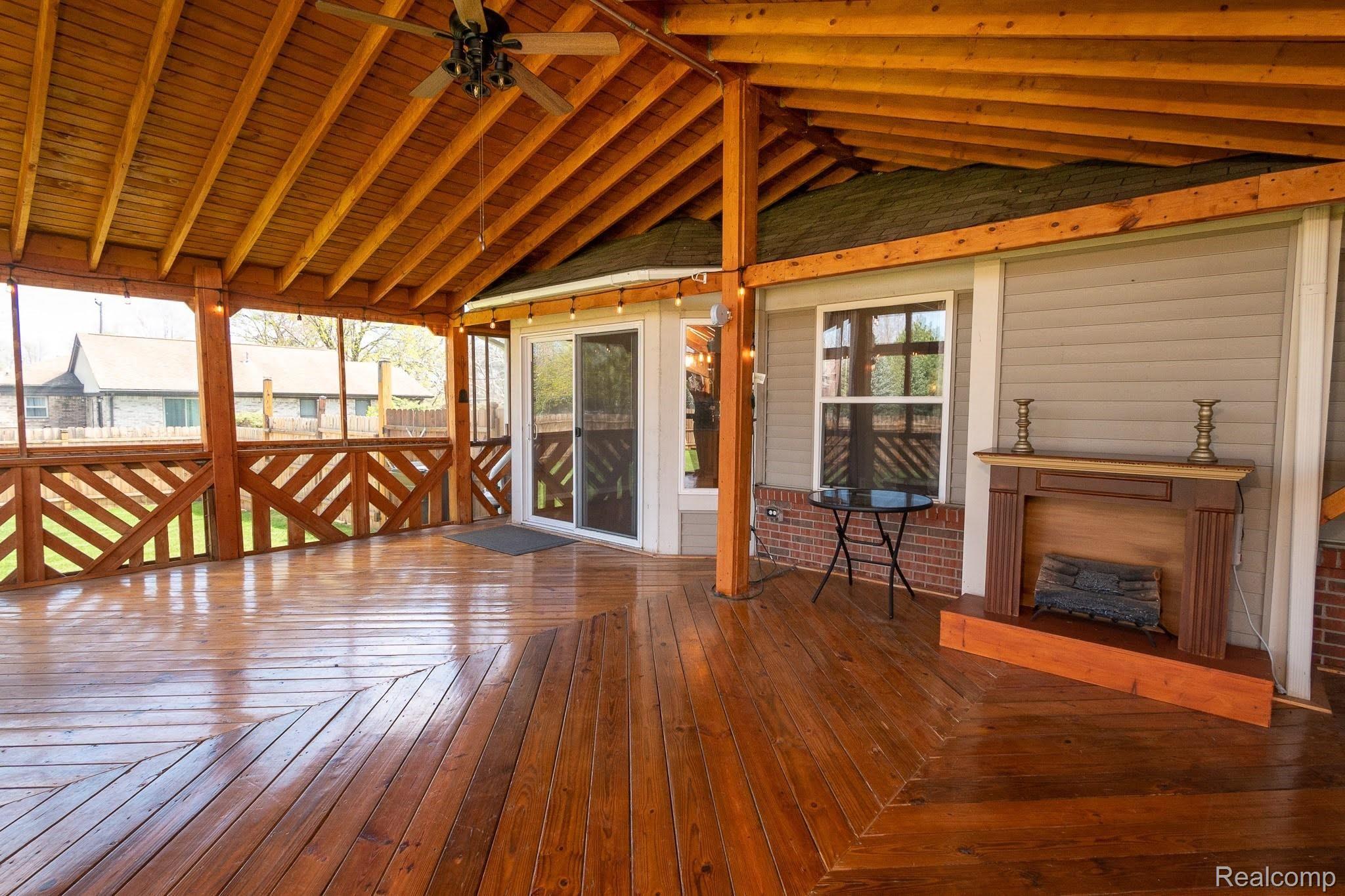 2457 Durham Road Utica, MI 48317 - Photo 8 of 27 Enormous wood deck with portable electric fireplace. Deck expands the length of the house, is covered and enclosed. No mosquitoes!