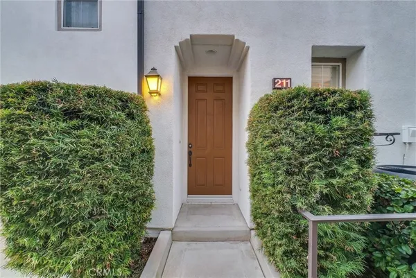 a front view of a house with plants