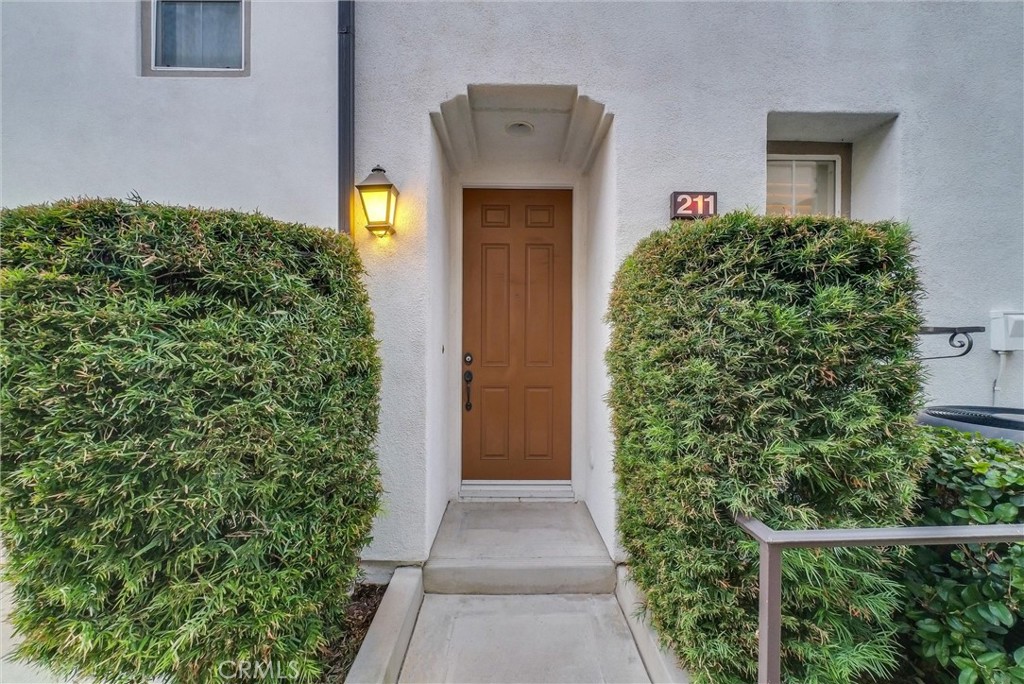 a front view of a house with plants
