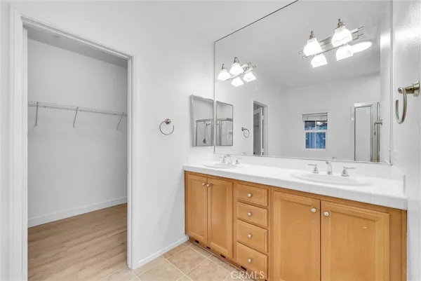a bathroom with a double vanity sink and a mirror