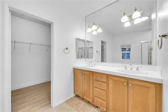 a bathroom with a double vanity sink and a mirror