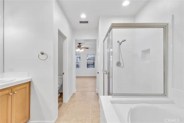 a bathroom with a shower and a glass door
