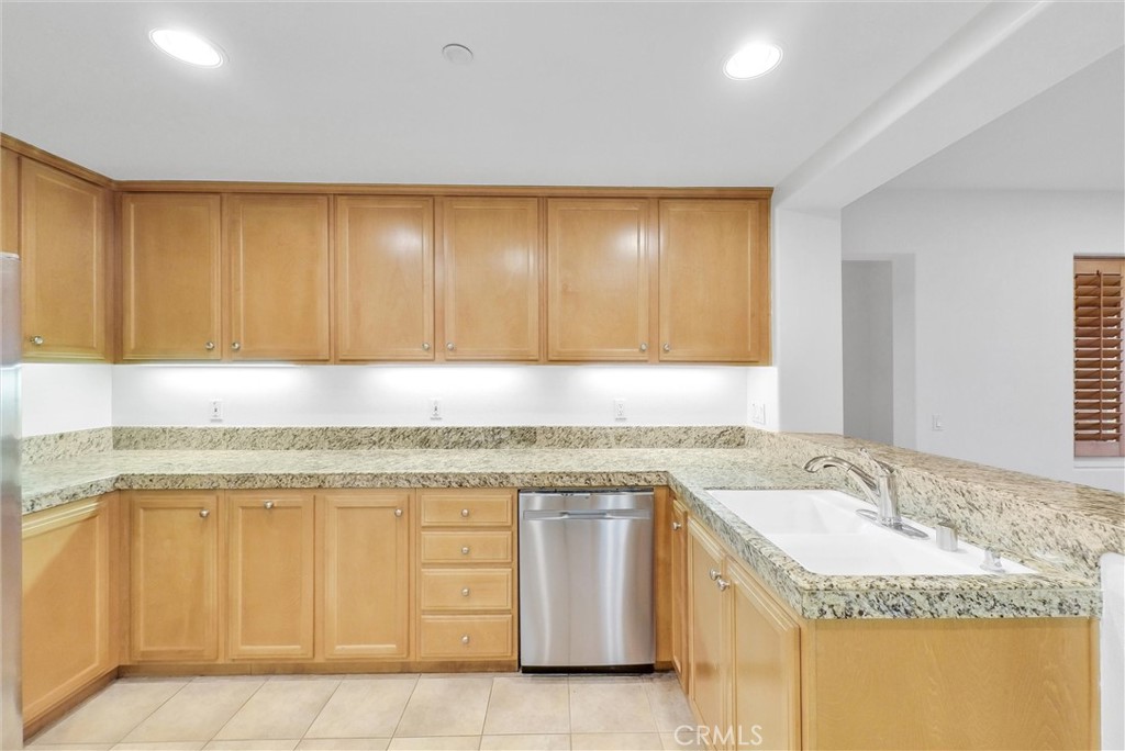 211 Lockford Irvine, CA 92602 - Photo 23 of 47 a kitchen with granite countertop sink and cabinets