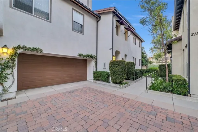 a front view of a house with a yard and a garage