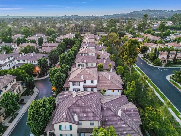 an aerial view of multiple houses with a yard