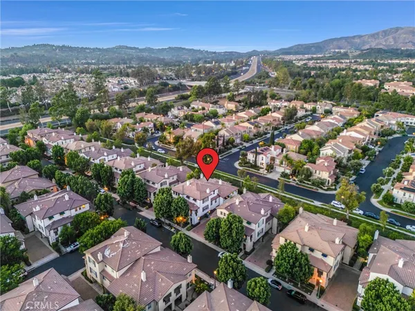 an aerial view of residential houses with outdoor space