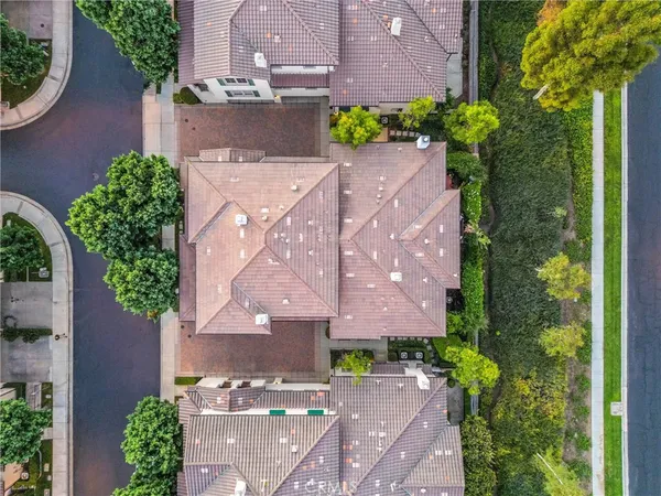 an aerial view of a house with a yard and a fountain