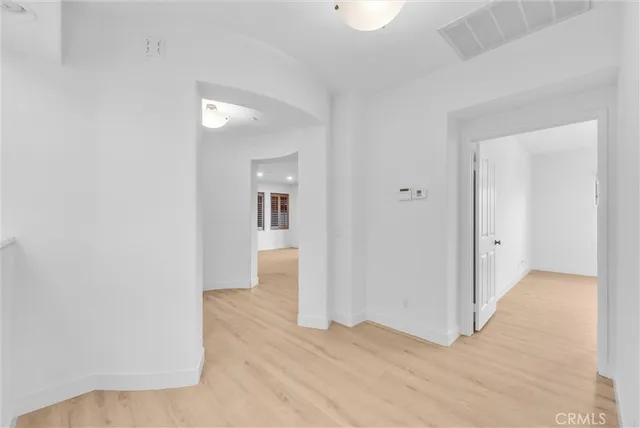 a view of a room with wooden floor and bathroom