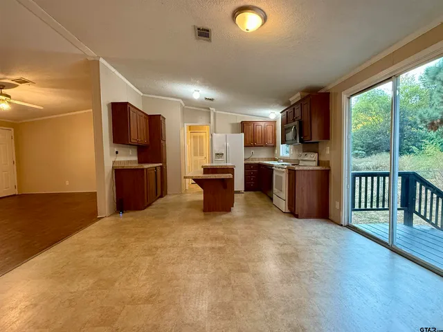 a kitchen with a refrigerator stove and microwave