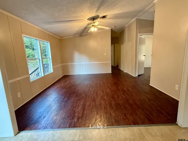 a view of a room with wooden floor
