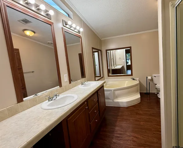 a white toilet sitting next to a bathroom sink