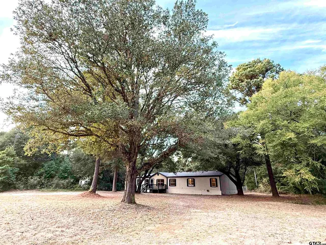 a view of a house with a snow in the yard