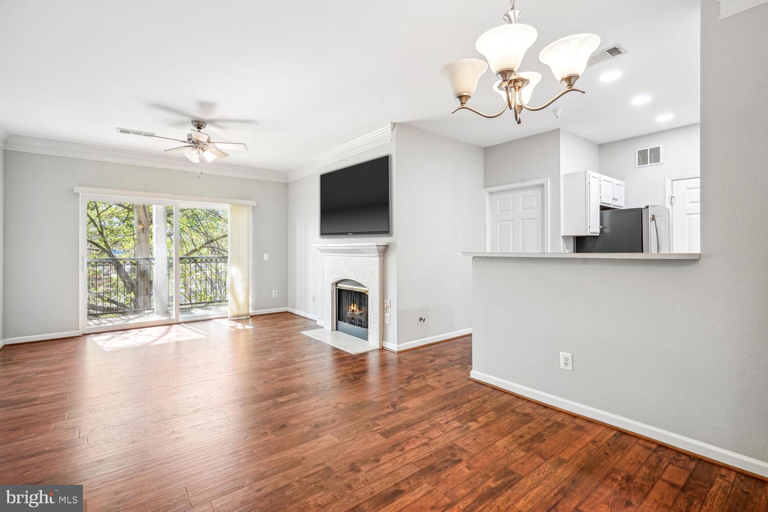 1601 Spring Gate Dr., Unit 1210 McLean, VA 22102 - Photo 2 of 18 a view of a room with wooden floor and chandelier