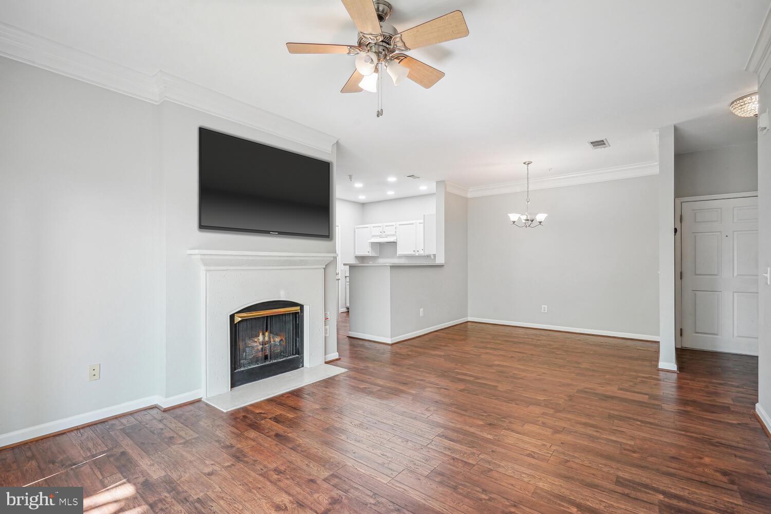 1601 Spring Gate Dr., Unit 1210 McLean, VA 22102 - Photo 3 of 18 a view of a livingroom with a fireplace a ceiling fan and fire place