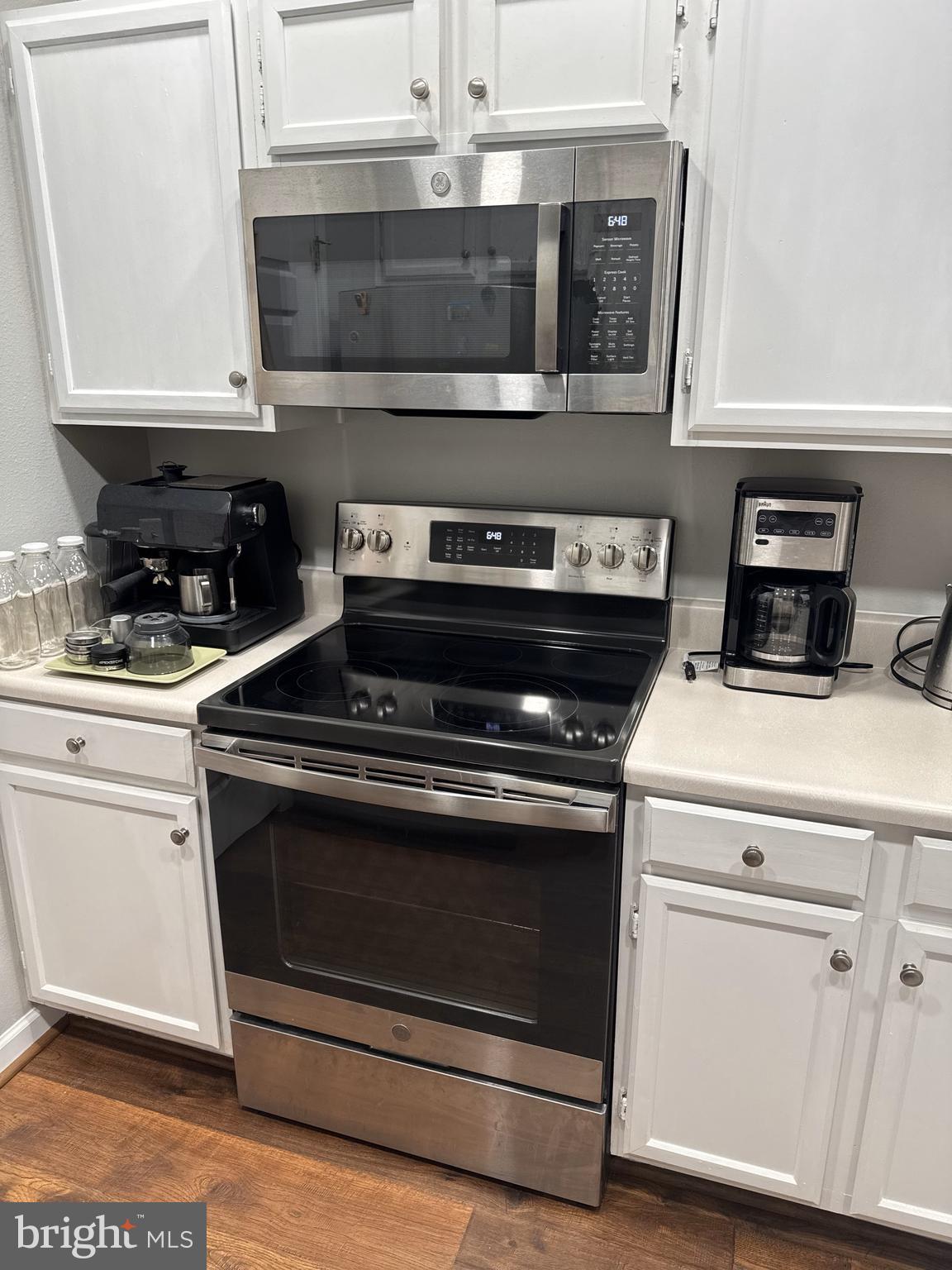 1601 Spring Gate Dr., Unit 1210 McLean, VA 22102 - Photo 5 of 18 a stove top oven sitting inside of a kitchen
