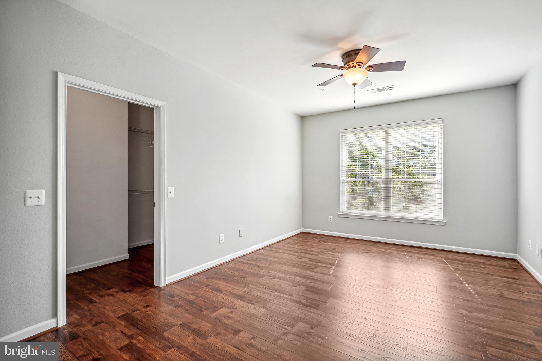 1601 Spring Gate Dr., Unit 1210 McLean, VA 22102 - Photo 9 of 18 a view of an empty room with wooden floor and a window