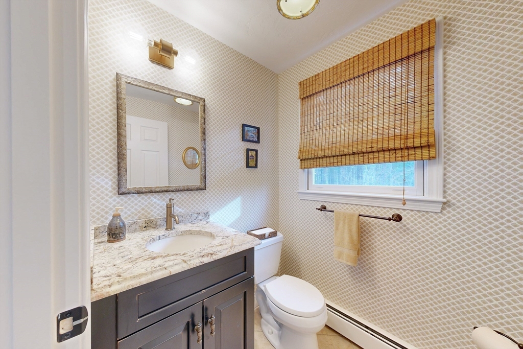 1 Chestnut Lane Medfield, MA 02052 - Photo 13 of 42 a bathroom with a granite countertop toilet sink and mirror