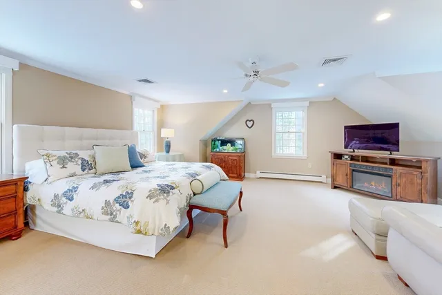 a spacious bedroom with a large bed and a couch