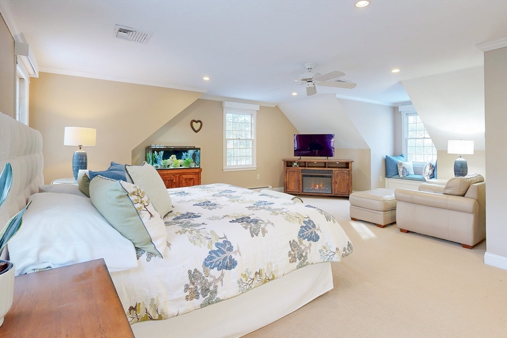 1 Chestnut Lane Medfield, MA 02052 - Photo 20 of 42 a spacious bedroom with a large bed and a couch
