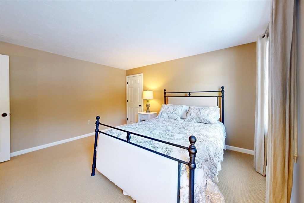 1 Chestnut Lane Medfield, MA 02052 - Photo 24 of 42 a bed sitting in a bedroom next to a window