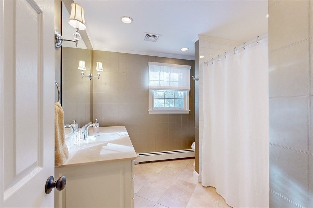 1 Chestnut Lane Medfield, MA 02052 - Photo 30 of 42 a bathroom with a sink a mirror and a shower