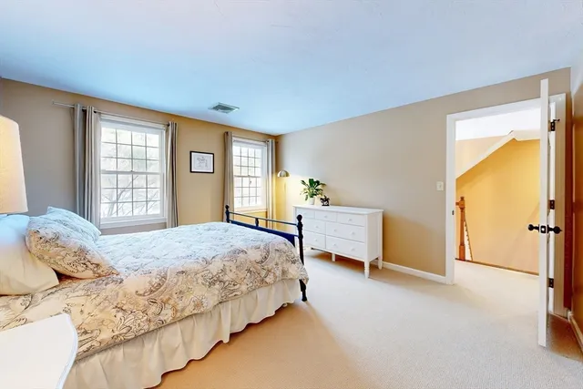 a bedroom with a large bed and a couch