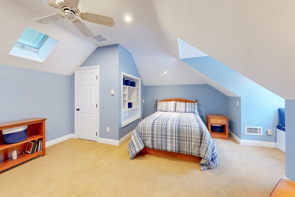 1 Chestnut Lane Medfield, MA 02052 - Photo 32 of 42 a bedroom with a bed and a lamp