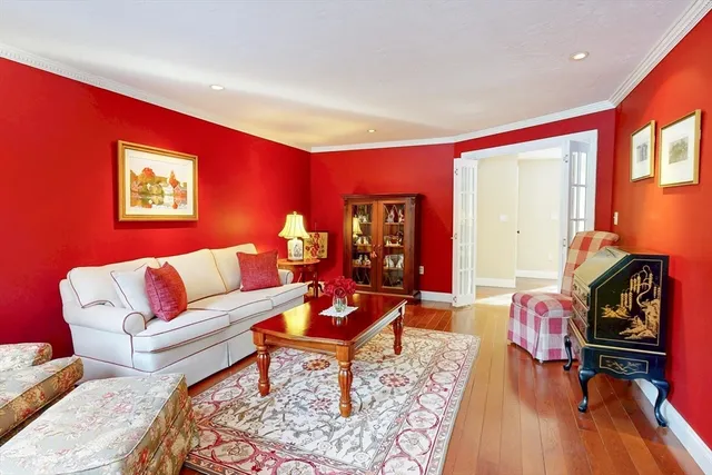 a dining room with furniture a chandelier and wooden floor