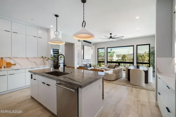 a kitchen with living room and white cabinets