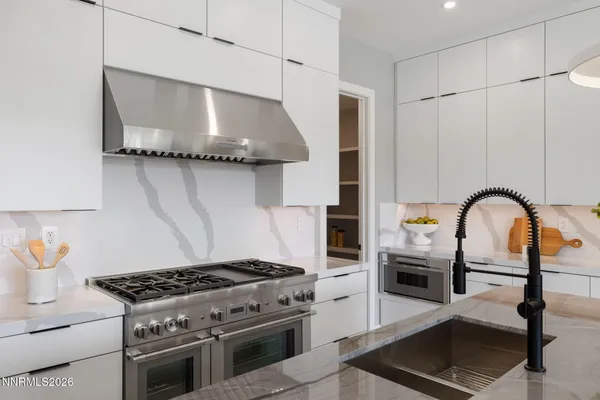 a kitchen with stainless steel appliances kitchen island granite countertop a refrigerator and a stove