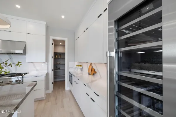 a kitchen with a refrigerator and a stove