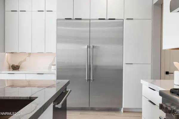 a kitchen with a sink a microwave and cabinets
