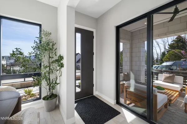 a balcony view with a couch and wooden floor
