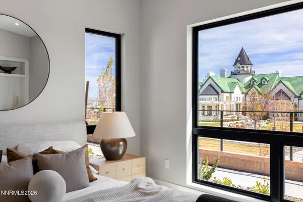 a bedroom with a bed and a large mirror