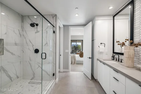 a bathroom with a granite countertop sink a toilet and mirror